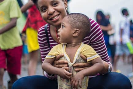 Photo by Lagos Food Bank Initiative: https://www.pexels.com/photo/shallow-focus-photo-of-a-mother-smiling-while-holding-her-child-8042461/