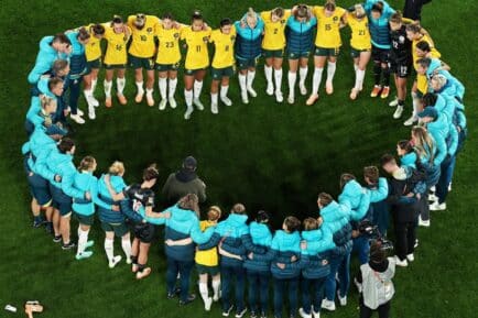 Matildas huddle in heart-shape formation after losing to England in the semi-final of the FIFA Women's World Cup.