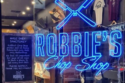 Robbie's Chop Shop in Adelaide, SA, with a sign out the front outlining their 'male only' policy.