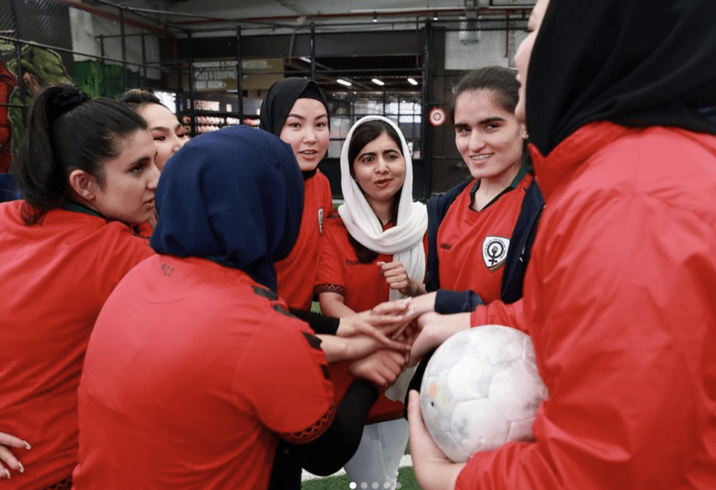 Malala supporting the Afghan women's football team in Melbourne.