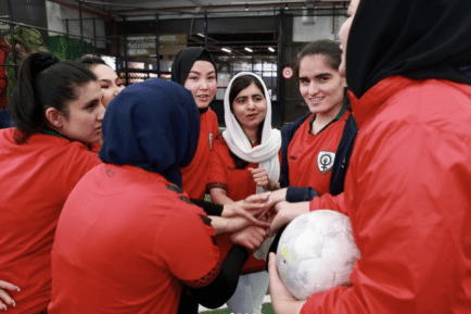 Malala supporting the Afghan women's football team in Melbourne.