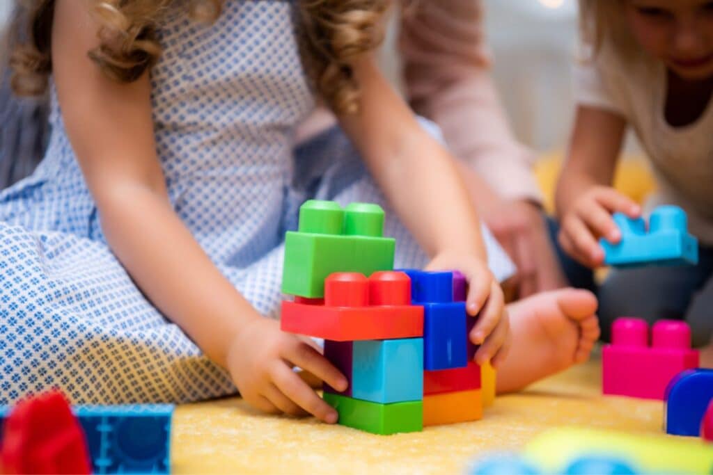 Young girl playing with colourful blocks. Credit: Shutterstock