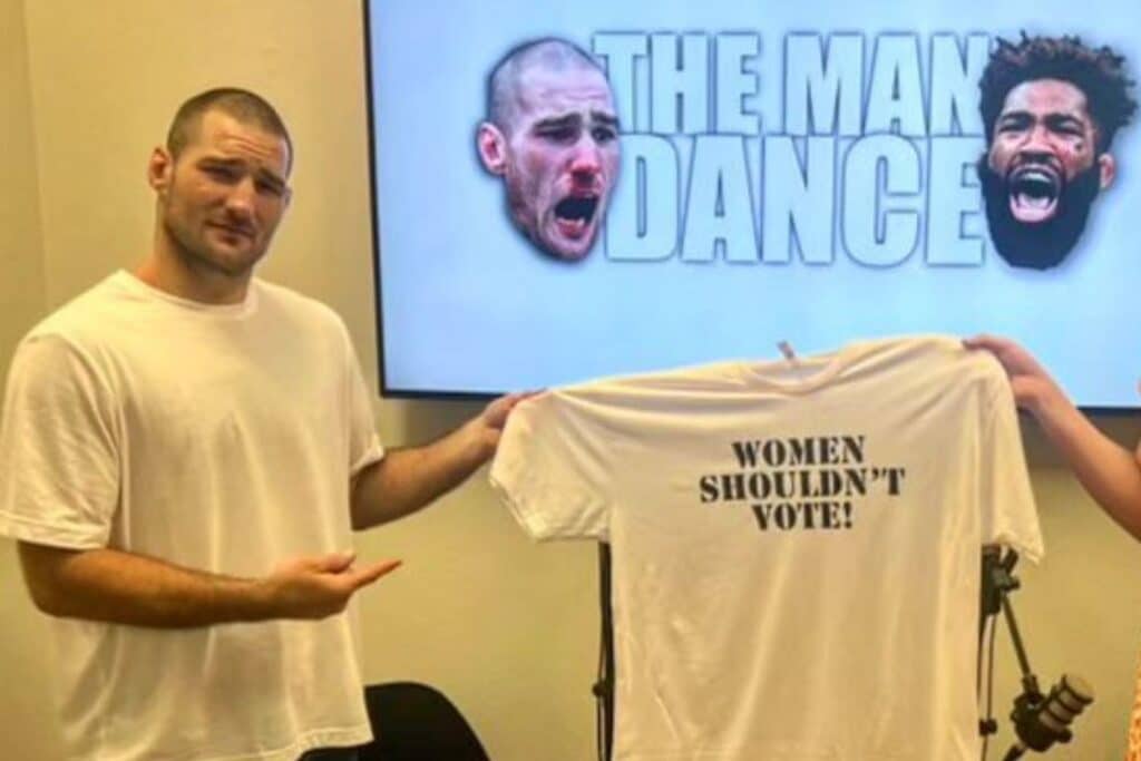 Sean Strickland, UFC fighter, holding a t-shirt that says 'Women Shouldn't Vote'