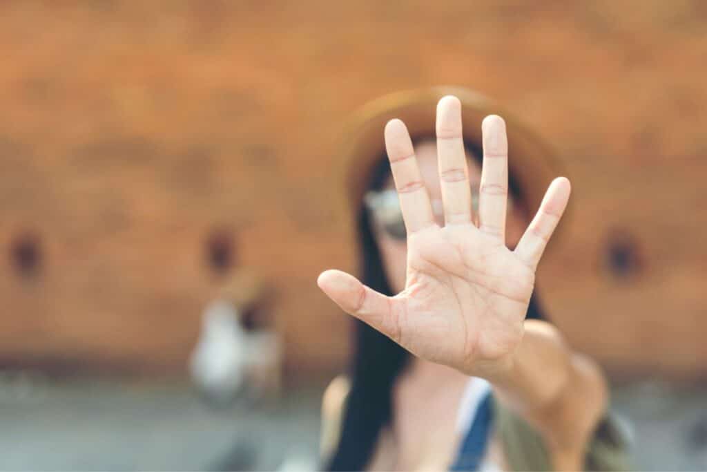 Woman holding up hand to say 'stop'