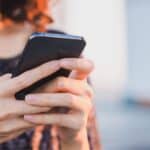 Woman holding phone and typing