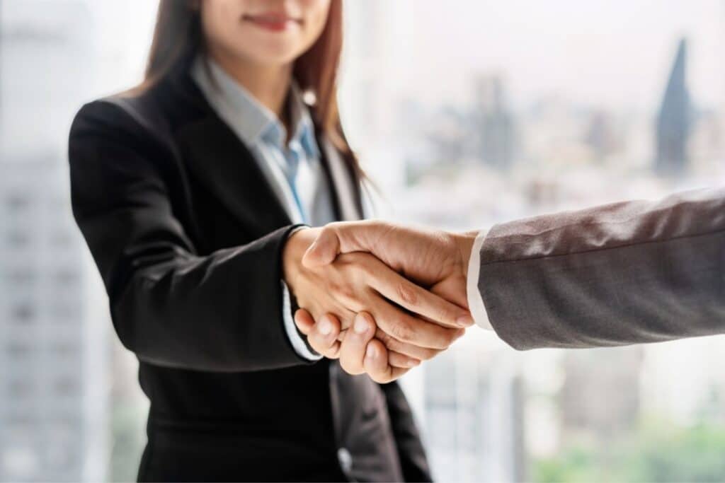 Woman shaking hand of man in suit