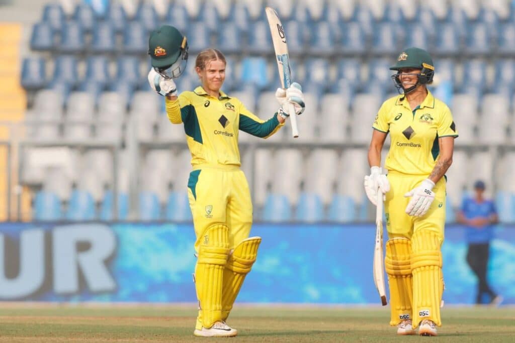 Phoebe Litchfield raising her bat, celebrating her second ODI century