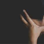 Woman holding head in hands